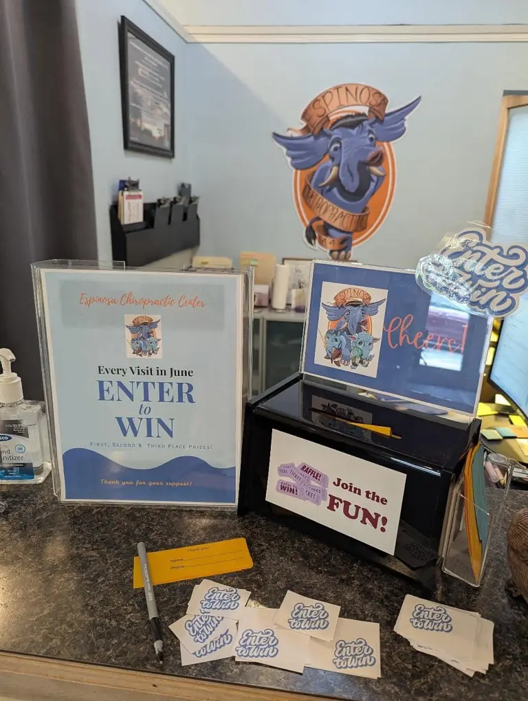 The front desk with the elephant logo on the wall above an Enter to Win box for the 25th anniversary