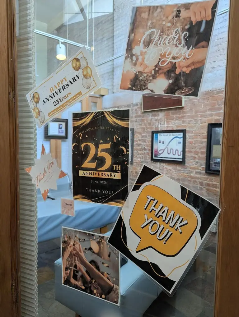 The office window decorated for the 25th anniversary in June 2026, with Thank you and Cheers signs